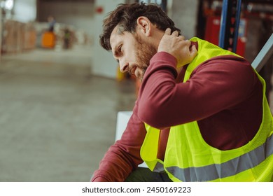 Tired, upset, sick bearded man, worker having neck and back pain, after work in warehouse, copy space. Concept of health care, treatment - Powered by Shutterstock