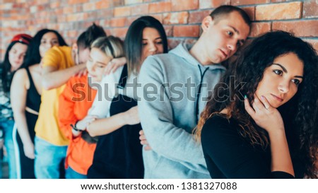Tired of waiting. Millennials queue. Men women standing in line leaning against brick wall. Moving forward with patience.