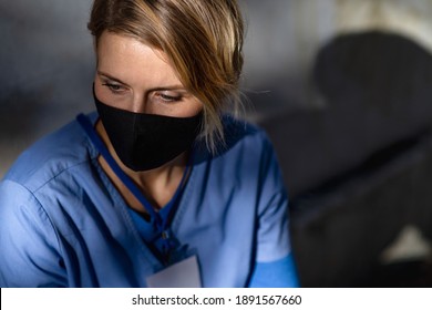 Tired Woman Caregiver, Nurse Or Healthcare Worker Sitting Outdoors On The Way To Work.