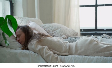 Tired woman falls down in the pillow. Woman falling into bed