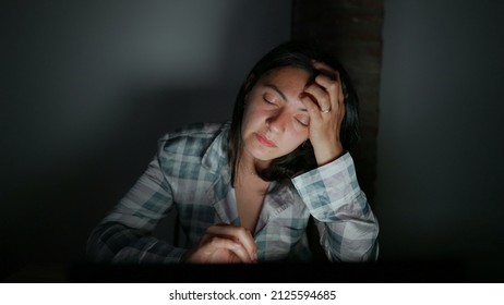 Tired Woman In Front Of Computer Screen At Night Alone