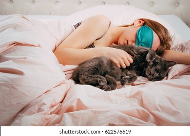 Tired Woman With Her Cat In Bed