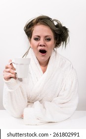 Tired Woman Holding Coffee Cup In Her Hand And Wearing A White Robe Wearing