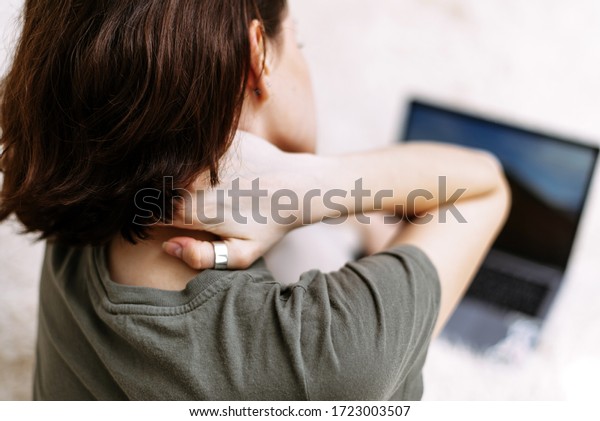 Tired woman massaging rubbing stiff sore neck\
tensed muscles fatigued from computer work in incorrect posture\
feeling hurt joint shoulder back pain ache, fibromyalgia concept,\
close up rear view.