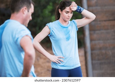 Tired woman resting on boot camp obstacle course - Powered by Shutterstock