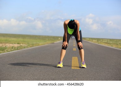 Tired Woman Runner Taking A Rest After Running Hard On Trail