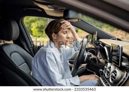 Tired woman stopped after driving car. Pensive sad middle aged female thinking about life troubles, has relationship problems. Depressed vehicle driver in automobile feeling bad. Burnout, exhaustion