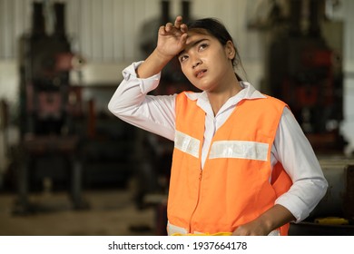 Tired Woman Worker Asian Labor Hard Work In Hot Factory Wiping Away Sweat