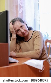 Tired Woman Working At Computer With Facial Mask