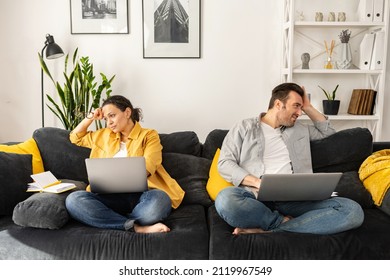 Tired from work on the distance middle-age couple sitting separate on the couch with laptops and looking in different sides, unemployed spouses has financial problems, wife and husband don't talk - Powered by Shutterstock