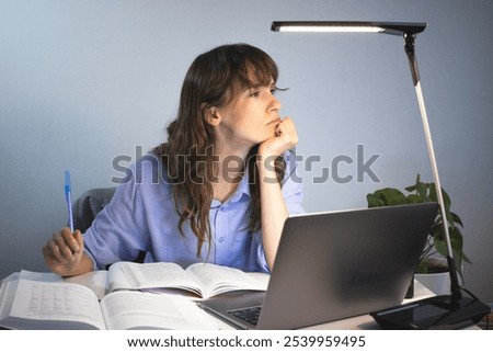 Tired worker working late in front of the laptop 