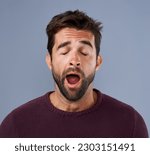 Tired, yawn and man in studio for fatigue or low energy against a grey background. Exhausted, yawning and face of bored male sleepy, lazy or suffering from insomnia, problem or burnout with emoji