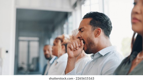 Tired, yawn and sleepless with a business man sitting in a meeting or presentation with his team for development. Yawning, exhausted and bored with a male employee suffering from insomnia at work