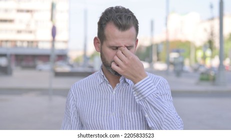 Tired Young Adult Man Rubbing Eyes Outdoor