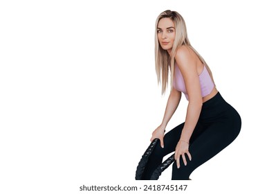 Tired young American young woman in sportswear leans on wall holds battle ropes resting after workout against transparent background. Weight loss exercise, healthy people. Fit girl at break - Powered by Shutterstock