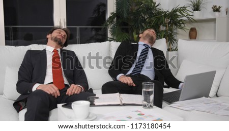 Tired Young Business Men Exhausted Day at Work Sleeping on Sofa in Modern Office