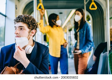 Tired young caucasian man with medical protective medical mask, lowered to the chin. Incorrect wearing of medical masks under quarantine at public transport inside. Wearing mask incorrectly. - Powered by Shutterstock