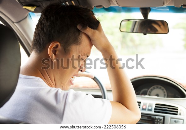 tired young man have a headache while driving\
car.Transportation concept\
