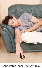 Tired Young Man Sleeping On A Sofa