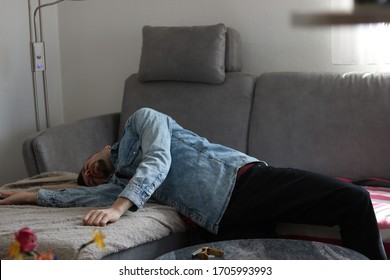 Tired Young Man Sleeping On Couch After Hangover 