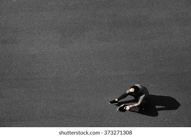 Tired young runner leaning over to catch his breath. Jogger asphalt after running and training exercise outside in summer. Caucasian man sports model. - Powered by Shutterstock