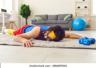 Tired Young Sportsman Sleeping On Rug After Failed Sports Workout At Home. Unmotivated Lazy Male Athlete In Glasses Lying On Floor After Giving Up Fitness Training With Dumbbells And Push-up Exercises