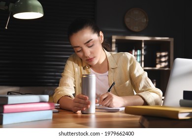 Tired Young Woman With Energy Drink Studying At Home