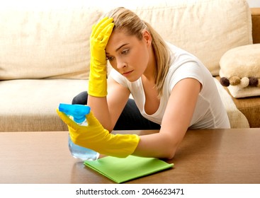 A Tired Young Woman Fed Up With Cleaning Her Home