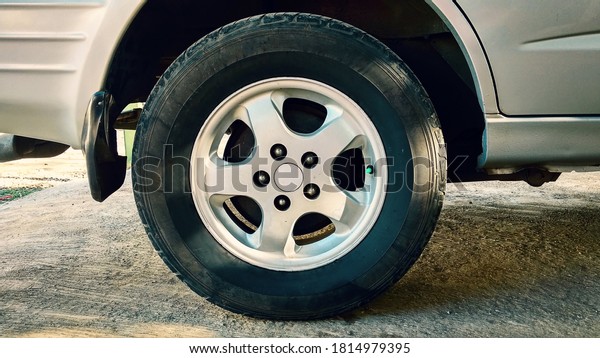 Tires on the road. Car\
tire, parked car.