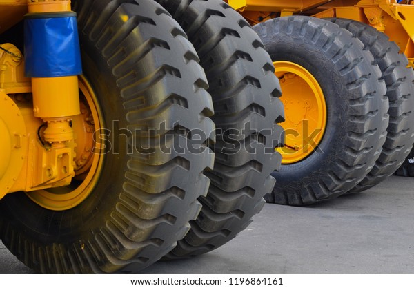 Tires with rims and electric motor-wheels\
engines of a yellow mining truck.\
Truck