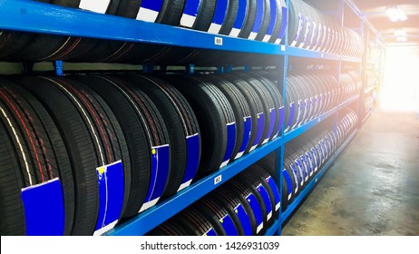 Tires For Sale At A Tire Store.car Tires Rack In Manufacturing Warehouse Background