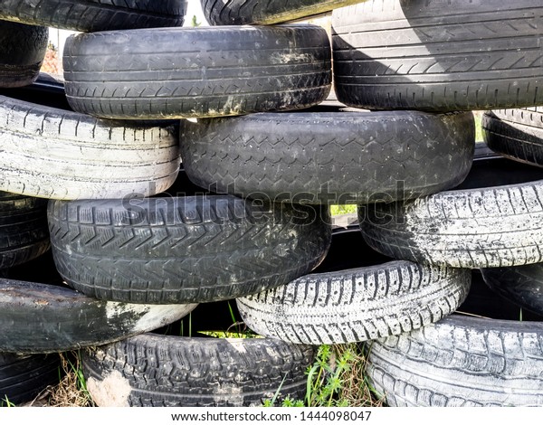 Tires\
stacked on top of each other. Large pile of tires dump. Illegal\
garbage dump. The concept of ecology\
pollution.
