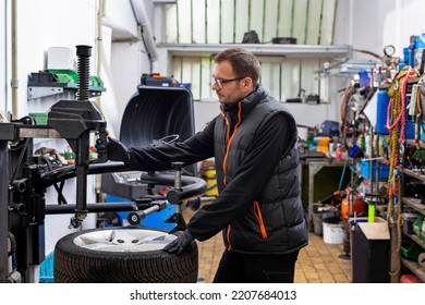 Tires Swap. The Vulcanizer Removes The Tire From The Rim. Car Repair In The Workshop