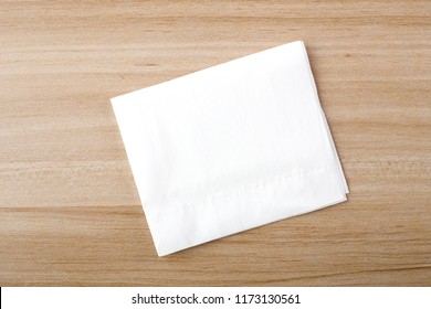 Tissue on the wooden table background.