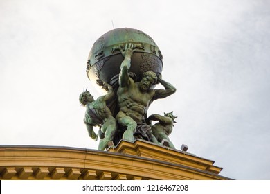 The titan called Atlas is carrying the world on his shoulders. Greek mythotology figure as  part of the historical train station roof built in 1888 in Frankfurt, Germany. 