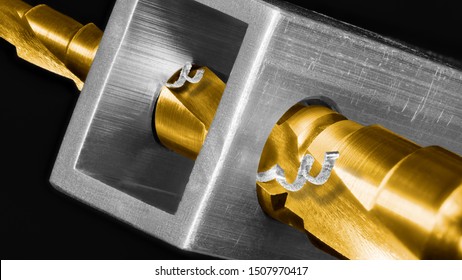 Titanium Coated Step Drill Bit In Artistic Detail On Black Background. Drilling Holes In An Aluminium Profile By Sharp Steel Unibit. Shiny Cutting Tool And Metal Shavings. Chip Machining In Metalwork.