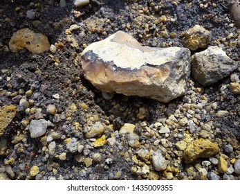 Titanium Ore In The Form Of Small Small Pieces With Admixtures Of Silicon Fragments. Loading From Wagons To Bunkers. Mining Processing Plant. Color Photo. Horizontal Frame