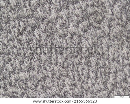 Titanium surface under the microscope. Metal surface. Surface treatment.
