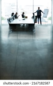 Titans Of Business At Work. Shot Of A Group Of Executives Having A Meeting In A Boardroom.