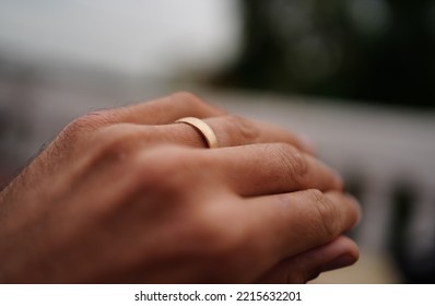 Titel: Matt Rose Gold Wedding Ring On A Husbands Hand.