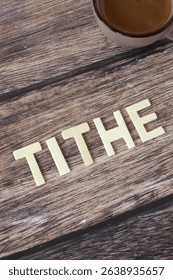Tithe wooden text on rustic background. Christian biblical concept of religious offering, blessing, and faith in God Jesus Christ.