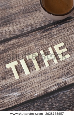 Tithe wooden text on rustic background. Christian biblical concept of religious offering, blessing, and faith in God Jesus Christ.