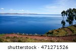 Titicaca or Titiqaqa is a large, deep lake in the Andes on the border of Peru and Bolivia. It is often called the highest navigable lake in the world.