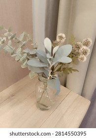 📌 Title:
Artificial Eucalyptus and Globe Thistle in Glass Vase
 
📌 Description:
Elegant arrangement of faux silvery eucalyptus leaves and neutral globe thistle blooms, displayed in clear glass jar vase. Placed on light wooden surface with soft neutral curtain background, perfect for Japandi, minimalist, rustic and modern home interior styling.