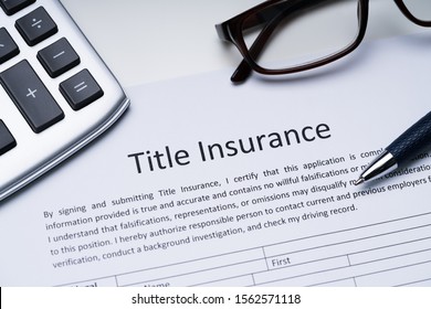 Title Insurance Form Near Calculator And Glasses