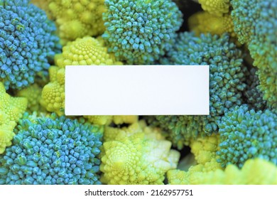 Title: Mockup Of A Blank Title Frame On A Background Lined With Green Broccoli And Yellow-green Romanesco