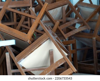 Title: Recycling dump with trash of broken chairs, wooden chairs. pile of chairs.