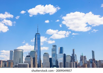 Title: Unique shape clouds float over the Lower Manhattan skyscraper in springtime at New York City NY USA on May 14 2021. Image was taken from Jersey City NJ.