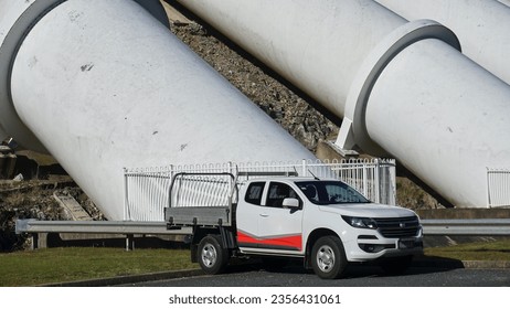 Title: A ute parked in front of the Massive Water Pressure pipes for producing Hydro Electric Power at Tumut 3 Power Hydro Electric Power Station

