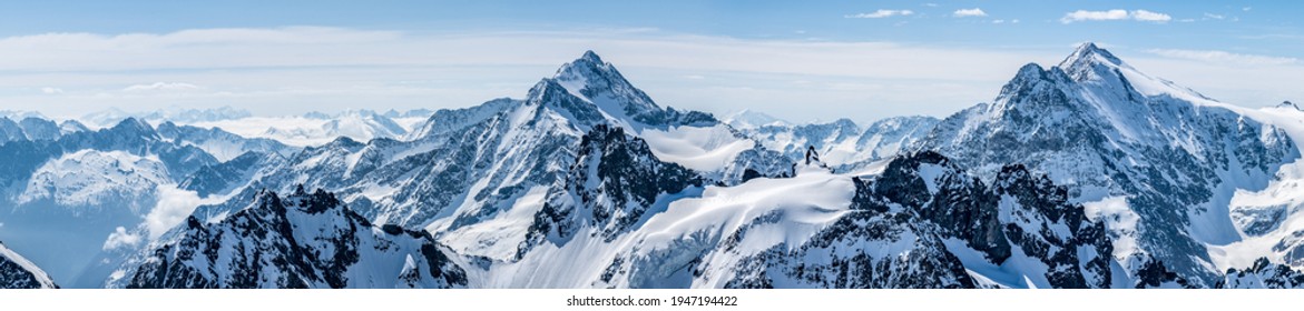 Titlis mountain. Beautiful panorama of snowy alps in white-blue tones.